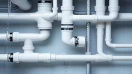 precision PVC fittings, adaptive, connecting various sizes of pipes, photorealistic, plumbing scene with detailed pipe layouts, highly detailed, water flowing through, superior connections, black, cooled spotlight, shot with a 85mm lens.