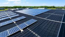 high-tech PVC roofing, innovative, used in a cutting-edge tech campus, photorealistic, adjacent to solar installations, highly detailed, precision-engineered textures, carbon black color, bright daylight, shot using panoramic lens